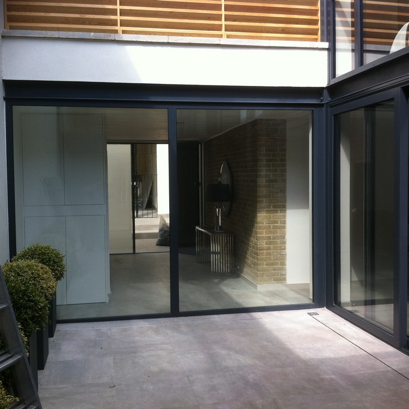 Floor-to-ceiling sliding doors opening to courtyard in Kilburn