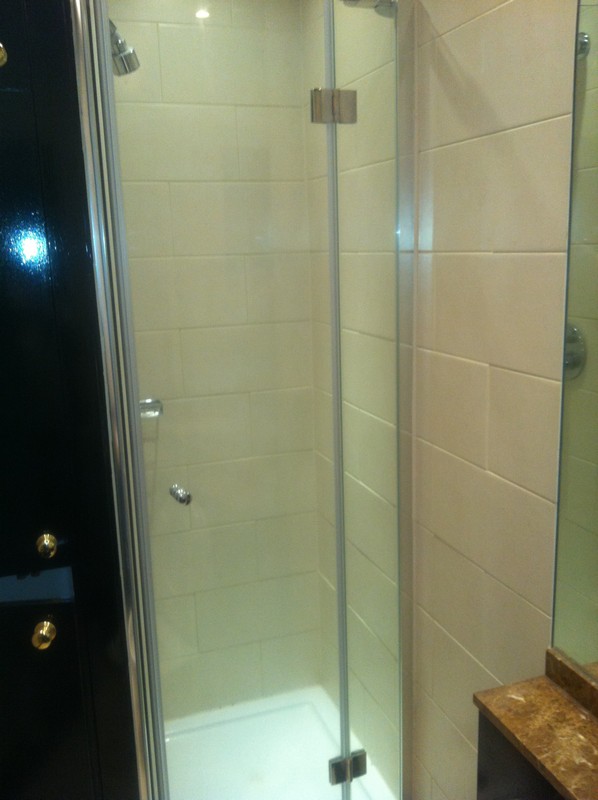 Frameless glass shower enclosure with chrome fittings in Kilburn