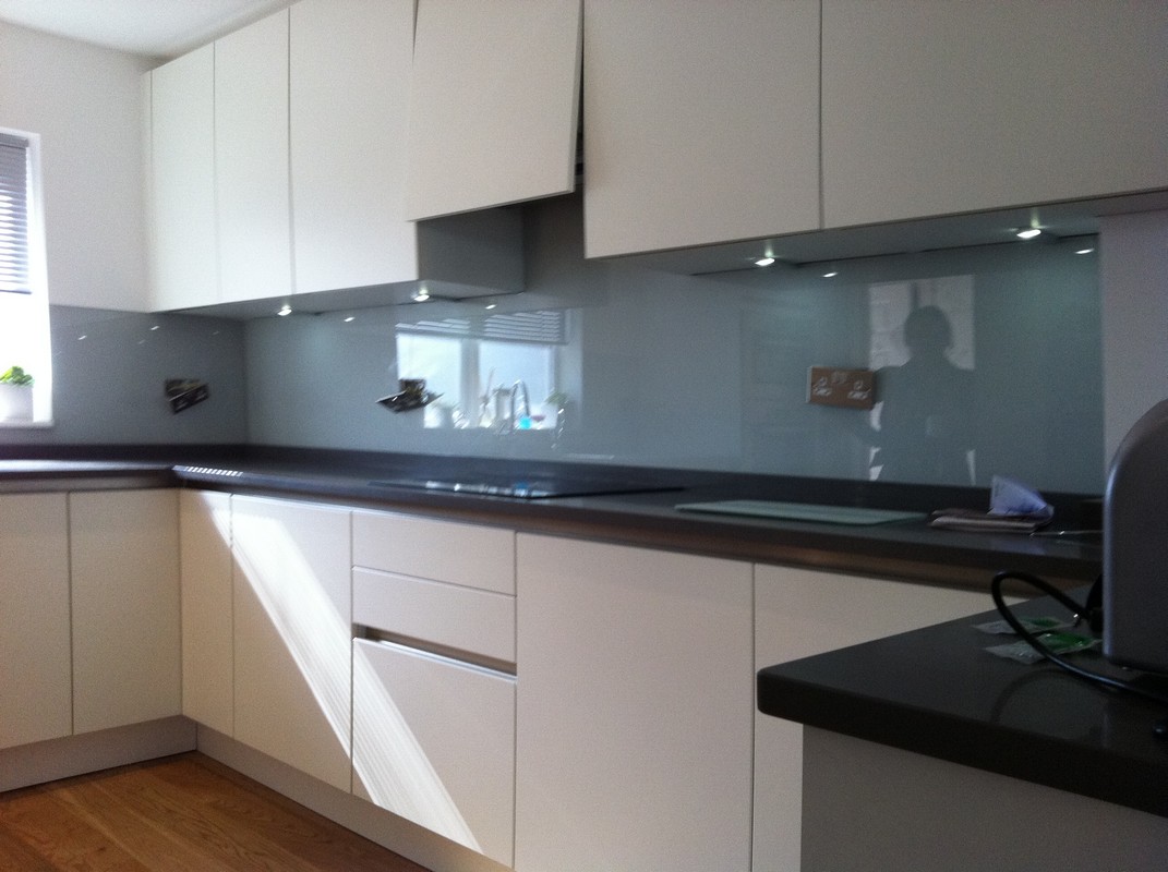 Grey glass kitchen splashback with LED lighting in Kilburn
