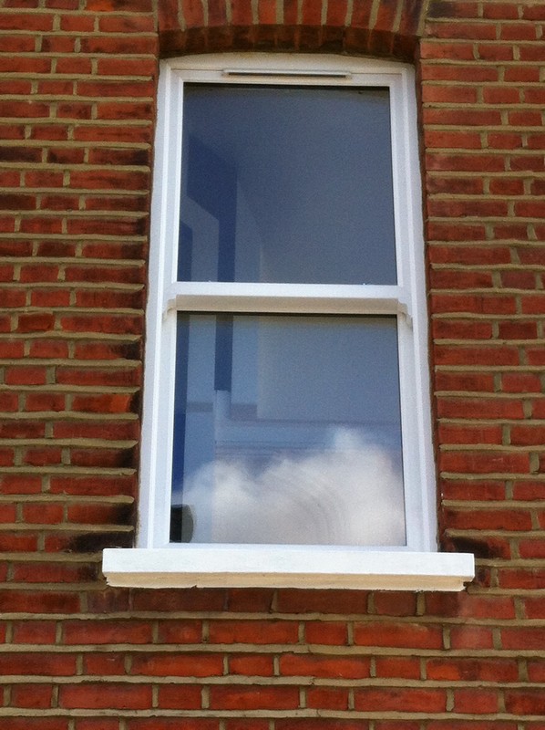 uPVC sash window on Victorian red brick house in Kilburn